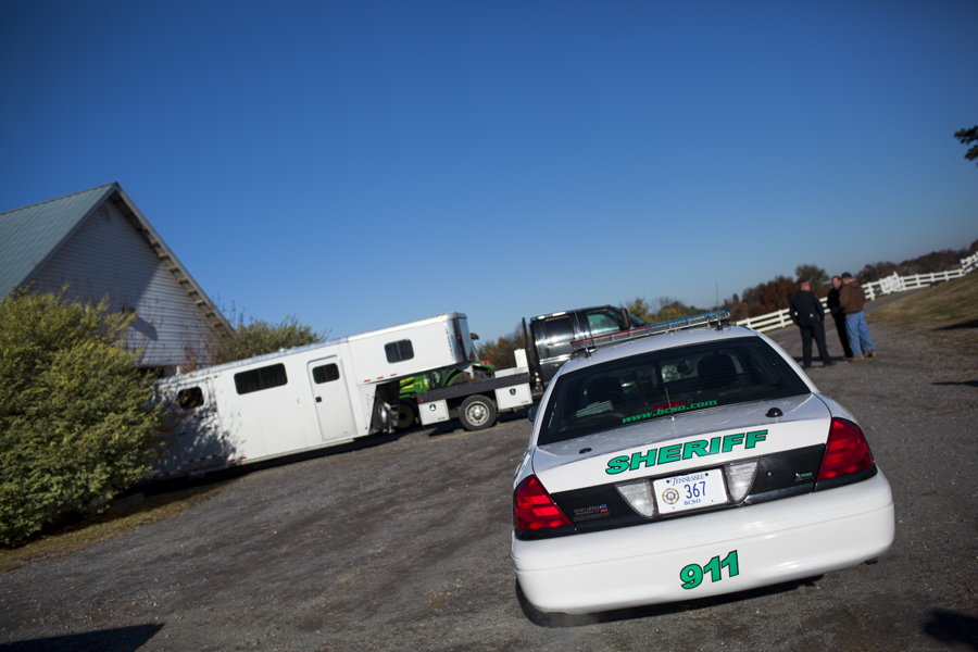 Two officers from the Blount County Sheriff's office stand with McNutt Farm owner, William McNutt, in front of the transport truck and trailer on November 8, 2013. Due to concerns over security, the transport vehicle removed its license plates and any identifying markings, and received a police escorted to McNutt Farm. (Photo: Adam McCauley)